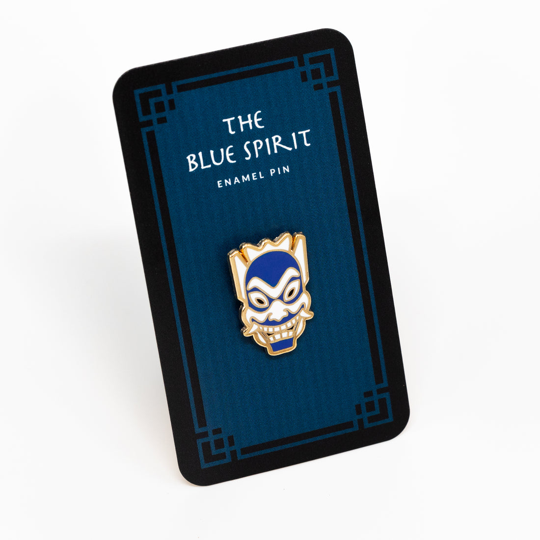 Blue spirit enamel pin on a dark blue backing card.